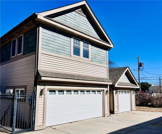 view of property exterior with fence and roof with shingles