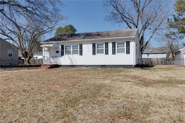 view of front facade with crawl space, a front yard, and fence