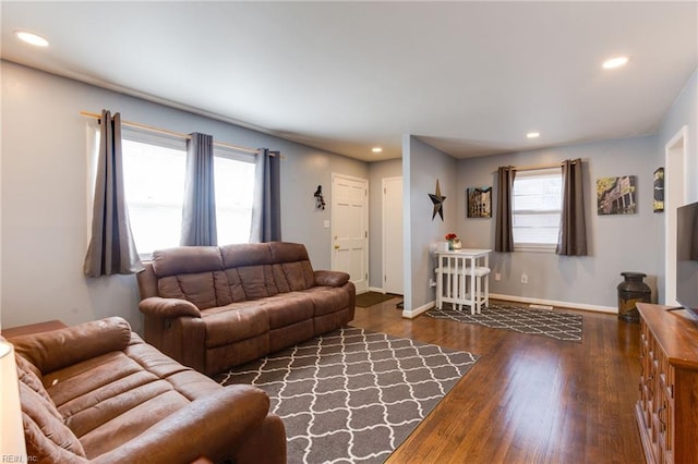 living area featuring baseboards, dark wood finished floors, and recessed lighting