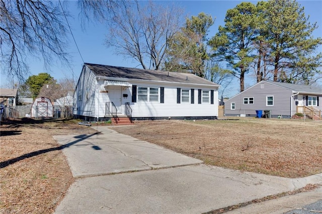 view of front of home featuring a front yard, concrete driveway, and crawl space