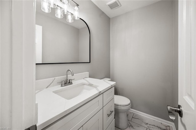 half bath with baseboards, visible vents, toilet, marble finish floor, and vanity