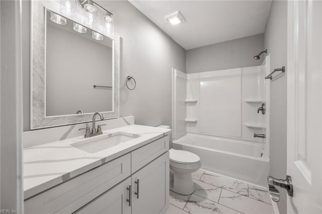 full bathroom with toilet, marble finish floor, washtub / shower combination, and vanity