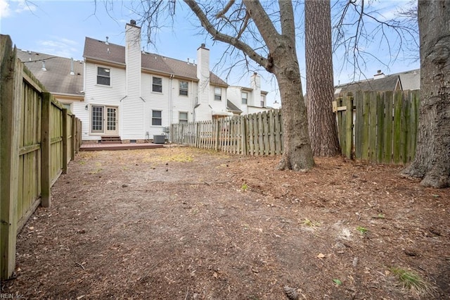 back of property featuring a fenced backyard and central air condition unit