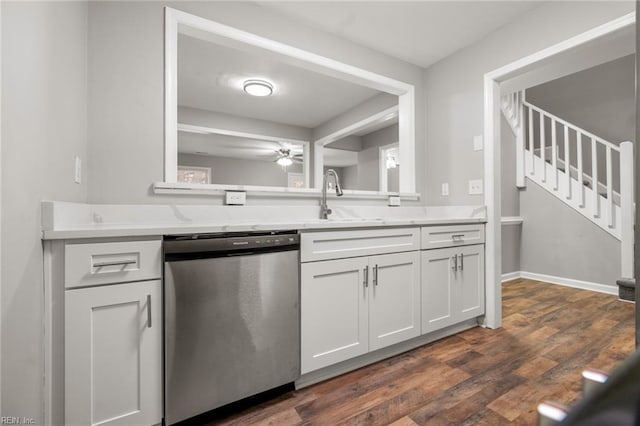 kitchen featuring dark wood-style flooring, a ceiling fan, white cabinets, light countertops, and stainless steel dishwasher