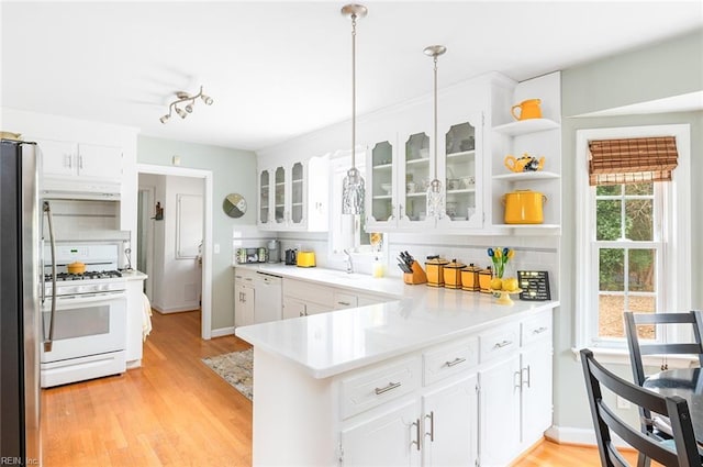 kitchen featuring glass insert cabinets, white appliances, white cabinets, and open shelves