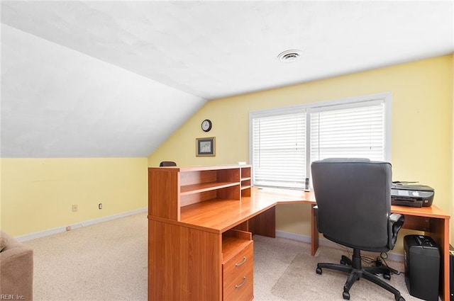 office area featuring light carpet, baseboards, visible vents, and lofted ceiling