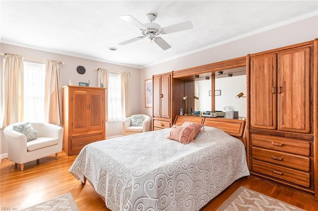 bedroom featuring ceiling fan, multiple windows, light wood-type flooring, and crown molding