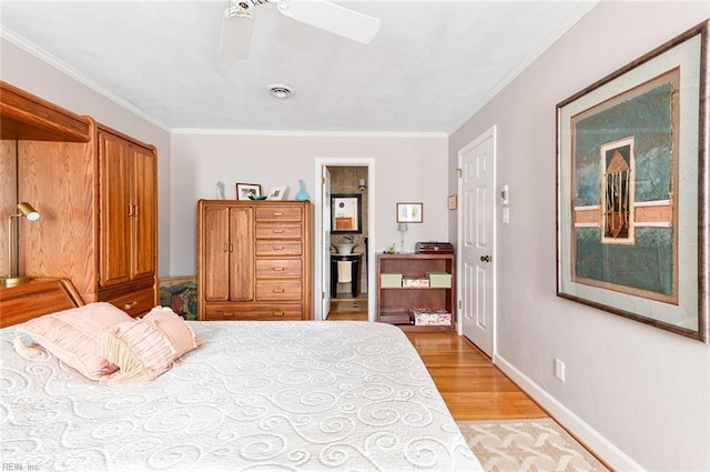 bedroom featuring a ceiling fan, visible vents, baseboards, ornamental molding, and light wood finished floors