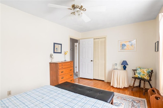 bedroom with ceiling fan, a closet, and light wood-type flooring