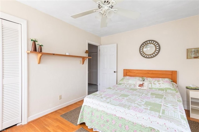 bedroom featuring a closet, ceiling fan, baseboards, and wood finished floors