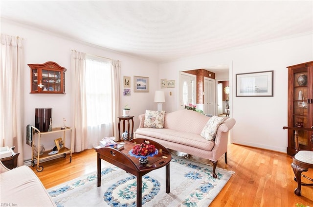 living area featuring light wood-style flooring and baseboards