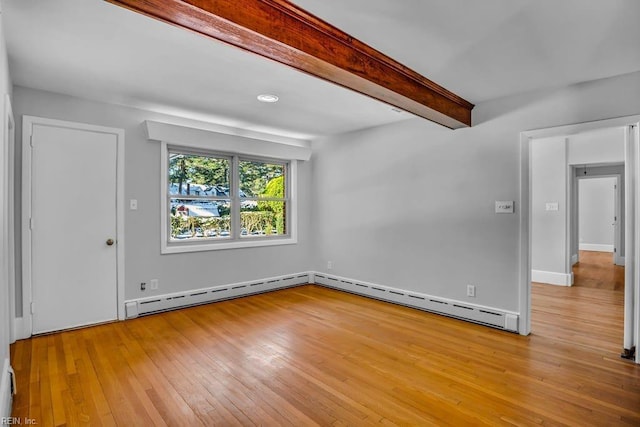 empty room with a baseboard radiator, beamed ceiling, baseboard heating, and light wood finished floors