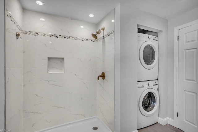 washroom featuring stacked washer and dryer, laundry area, and recessed lighting