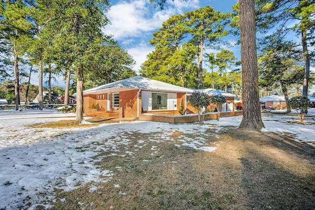 view of front of property featuring brick siding