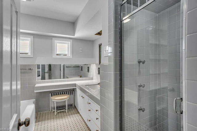 full bathroom with a shower stall, visible vents, tile walls, and vanity