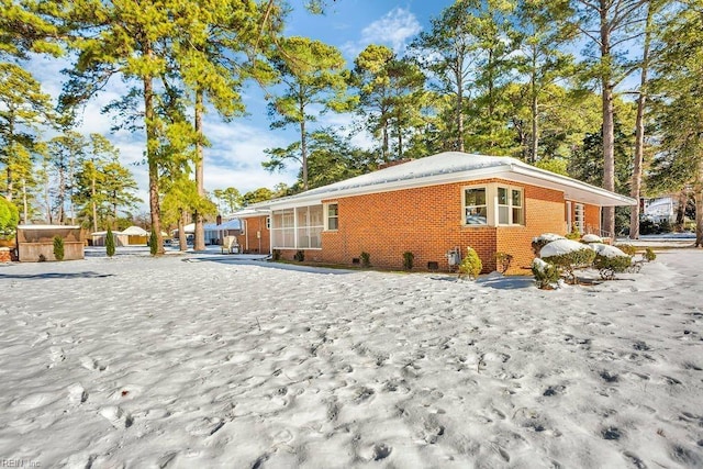 view of side of home with brick siding