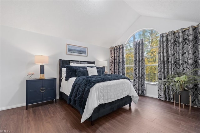 bedroom featuring lofted ceiling, multiple windows, and dark wood-style floors