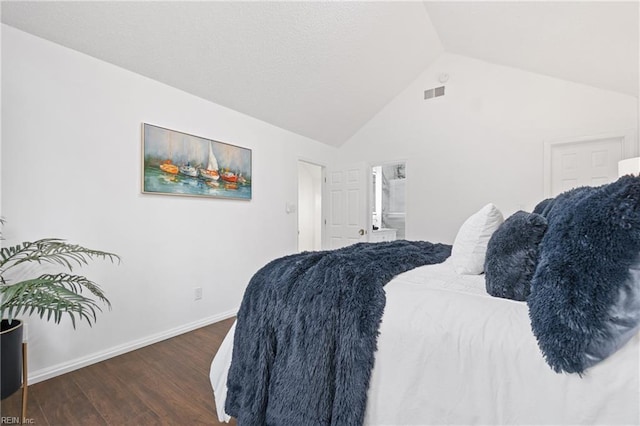 bedroom featuring dark wood-style flooring, lofted ceiling, visible vents, connected bathroom, and baseboards