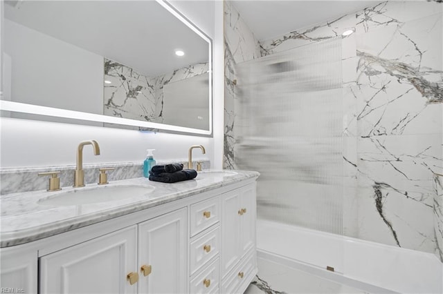 bathroom featuring marble finish floor, a sink, and double vanity