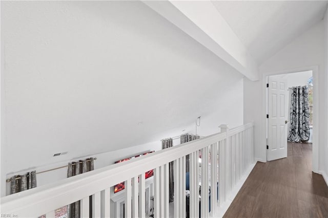 hall featuring dark wood-style floors, lofted ceiling, and baseboards