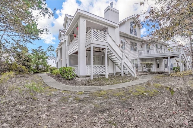 view of front of home with stairway and a chimney