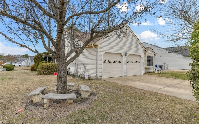 view of property exterior with concrete driveway, a yard, and an attached garage