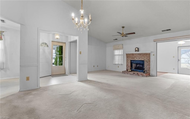 unfurnished living room with ceiling fan with notable chandelier, a fireplace, visible vents, and light colored carpet