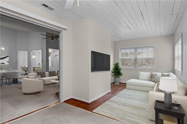 living room with wooden ceiling, ceiling fan, visible vents, and a wealth of natural light