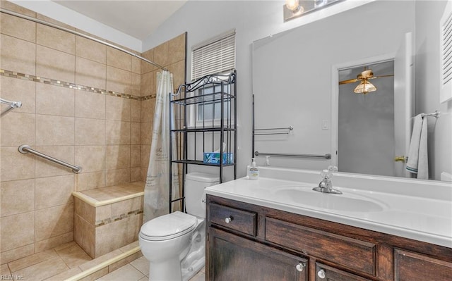 bathroom featuring tiled shower, toilet, lofted ceiling, tile patterned flooring, and vanity