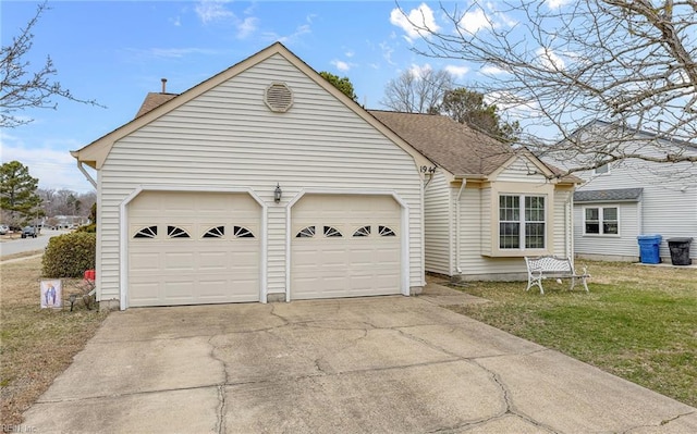 view of front of house with driveway, a garage, a front lawn, and roof with shingles