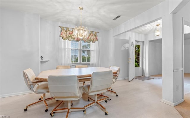 dining space with baseboards, visible vents, and a chandelier