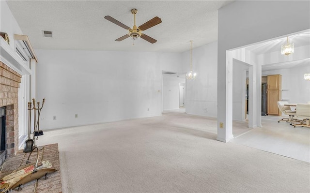 living area with visible vents, a brick fireplace, light carpet, high vaulted ceiling, and ceiling fan with notable chandelier