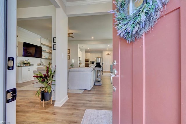 foyer entrance featuring recessed lighting, light wood-style flooring, baseboards, and ornamental molding