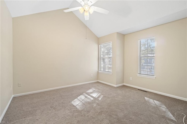 unfurnished room with lofted ceiling, carpet, and baseboards