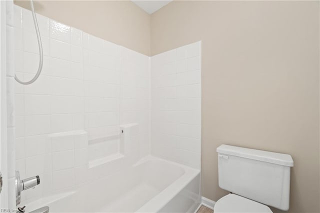 full bathroom with toilet, baseboards, and bathing tub / shower combination