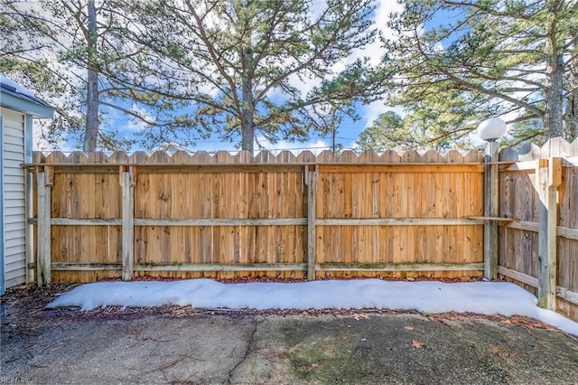 yard covered in snow featuring fence