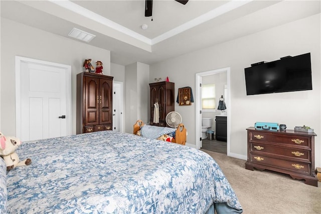 bedroom featuring ceiling fan, light colored carpet, visible vents, baseboards, and a raised ceiling