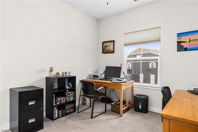 office space with light carpet and baseboards