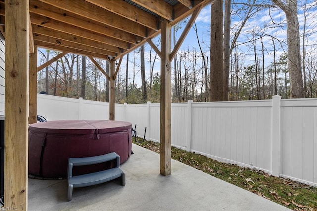 view of patio with a fenced backyard and a hot tub