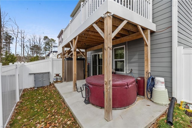 view of patio with a fenced backyard and a hot tub