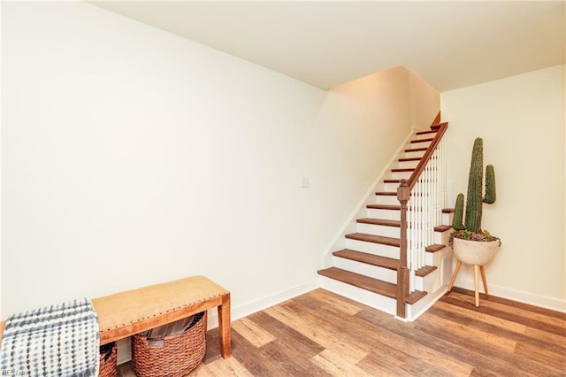 stairs with baseboards and wood finished floors