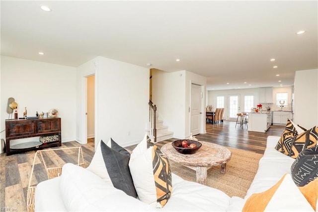 living room featuring recessed lighting, stairway, baseboards, and wood finished floors