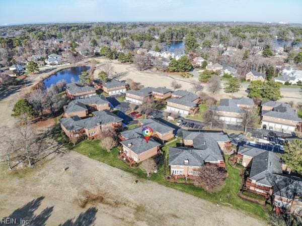 drone / aerial view with a residential view and a water view