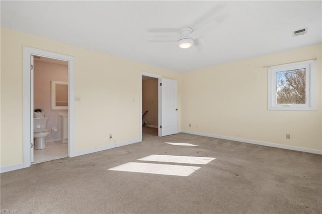 unfurnished bedroom featuring light carpet, baseboards, visible vents, and connected bathroom