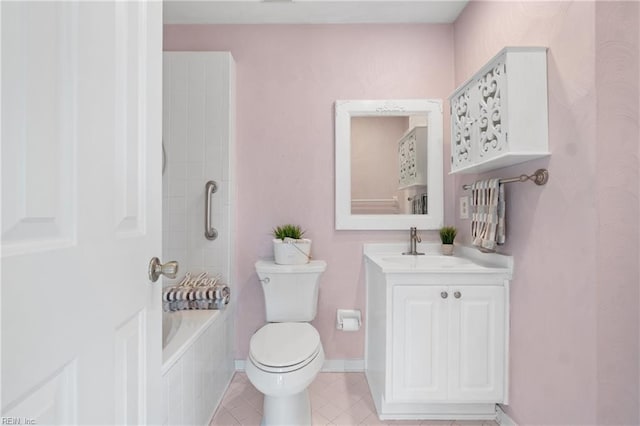 bathroom with a tub to relax in, toilet, vanity, tile patterned flooring, and baseboards