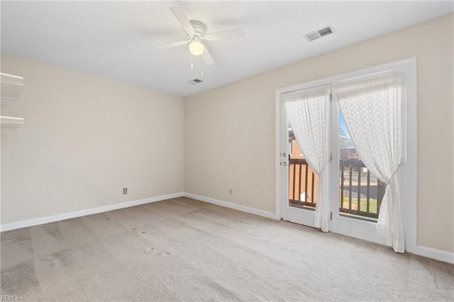 empty room featuring ceiling fan, baseboards, visible vents, and light colored carpet