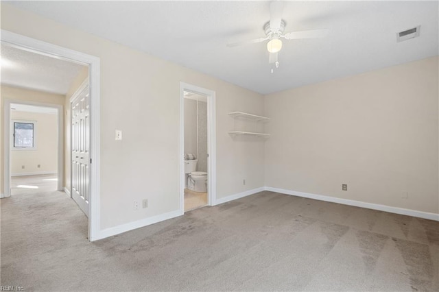 unfurnished bedroom featuring baseboards, visible vents, a closet, and light colored carpet