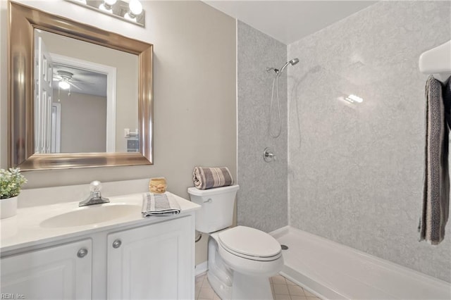 bathroom with a shower, vanity, toilet, and tile patterned floors