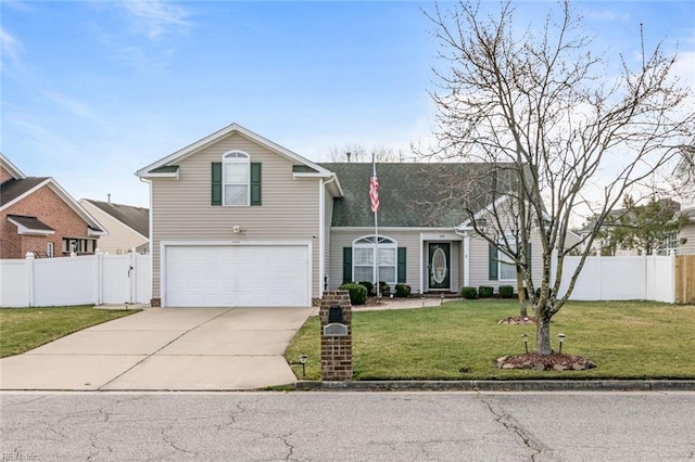 traditional home with a front yard, fence, driveway, and an attached garage