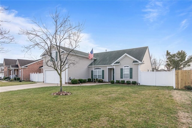 view of front of property with a garage, concrete driveway, a front yard, and fence